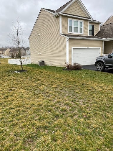 homeowners yard with a tint of yellow grass