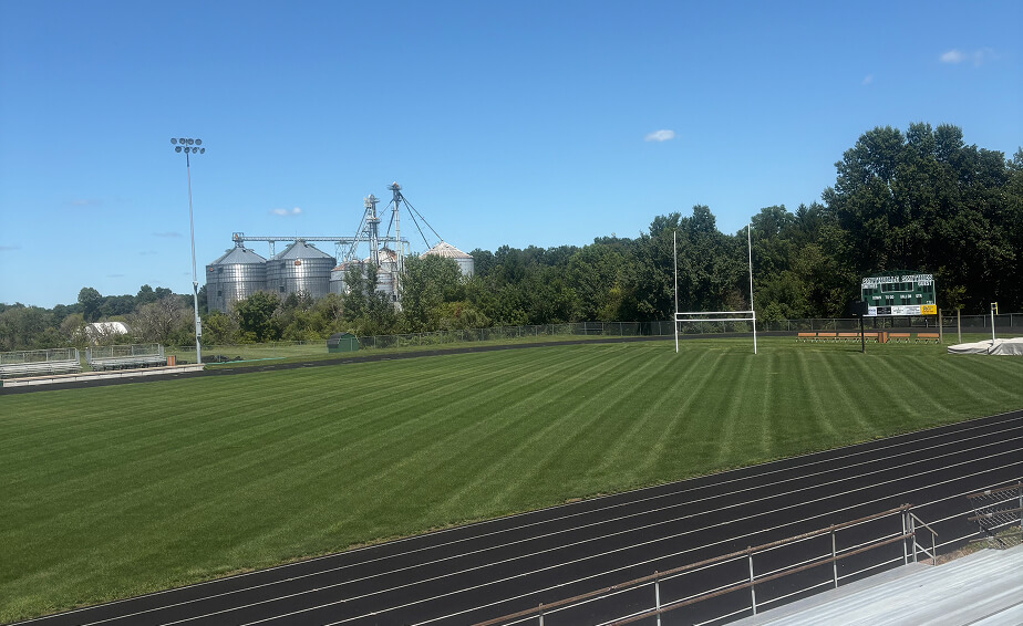Athletic field with thick, striped green turf 1½ weeks after a Carbon Complete application